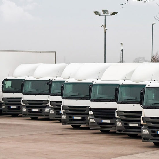 Parked fleet of lorries lined up to promote Greenfield Risk Solutions Insurance Brokers - Motor Fleet Insurance